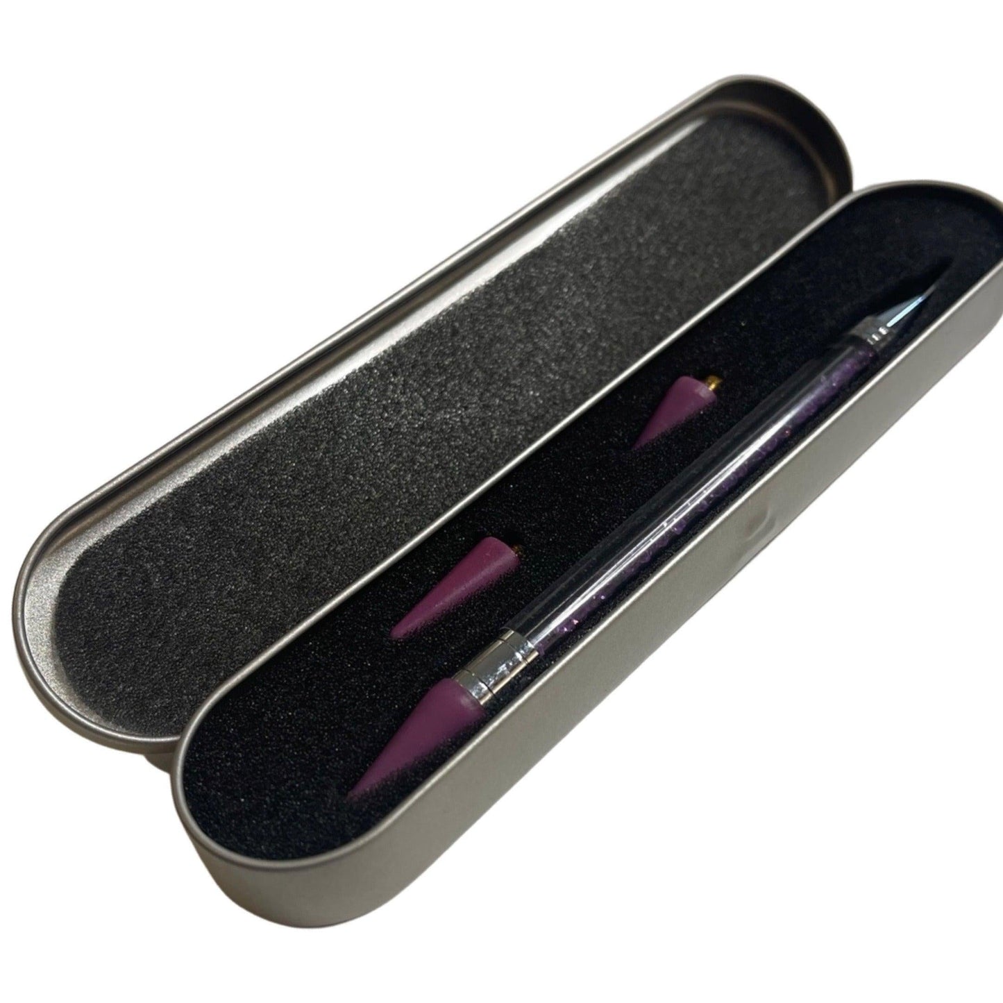 Dual tip jewel picker wax pen for rhinestones and nail art



Close-up of wax tip jewel picker tool



Jewel picker pen in use with rhinestones and gems