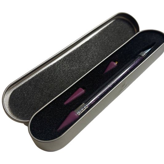 Dual tip jewel picker wax pen for rhinestones and nail art



Close-up of wax tip jewel picker tool



Jewel picker pen in use with rhinestones and gems